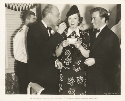 Los Angeles: Paramount Pictures, 1936. Vintage press photograph of Mitchell Leisen, Myrna Loy, and J...