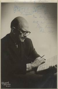 Photograph of the composer, manuscript in hand, with autograph musical quotation from his Violin Concerto signed in full