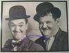 An Oversized Stan Laurel & Oliver Hardy Photograph, Showing Them In Their Trademark Bowler Hats