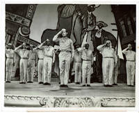 image of A VINTAGE PUBLICITY PHOTOGRAPH of U.S. Soldiers performing in the Hollywood movie production "THIS IS THE ARMY", with HEAVYWEIGHT BOXING CHAMPION SGT. JOE LOUIS in the foreground.
