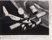 [Artist’s concept of two winged shuttles delivering men and cargo to an orbiting space station.]