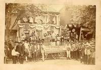 Photograph of Group of Men in Costume, Surrounding the Parade Wagon of E. A. Bloser Wholesale & Retail Jeweler