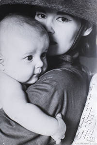 Large black and white photograph of Gloria Vanderbilt holding an infant