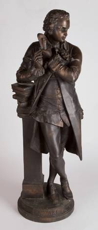 Bronze statue of Mozart full length standing and holding a rolled sheet of paper in his right hand and a writing implement in his left. 20th century