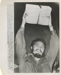 Original press photograph of Fidel Castro holding a bundle of checks, 1959