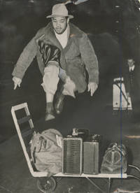 Original press photograph of Joe Louis jumping over a luggage cart, 1947