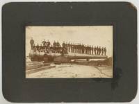 [Photograph]: Military officers standing on a huge Coastal artillery gun