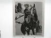 8x10 signed black and white photograph of Gene Autry, “America’s favorite singing cowboy”, on horseback.