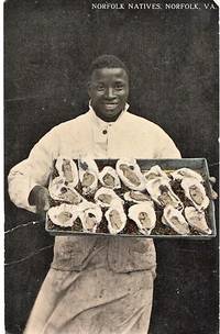 cover of "NORFOLK NATIVES": TINTED, REAL-PHOTO POSTCARD OF AN AFRICAN-AMERICAN CHEF DISPLAYING A LARGE TRAY OF OYSTERS ON THE HALF-SHELL