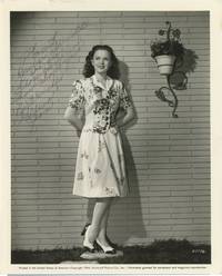 Six original publicity photographs of Gloria Jean, one INSCRIBED by the actress, 1939-1944