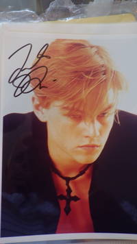 SIGNED  Color Photograph Leonardo DiCaprio in Black Coat looking Pensive wearing Black Cross