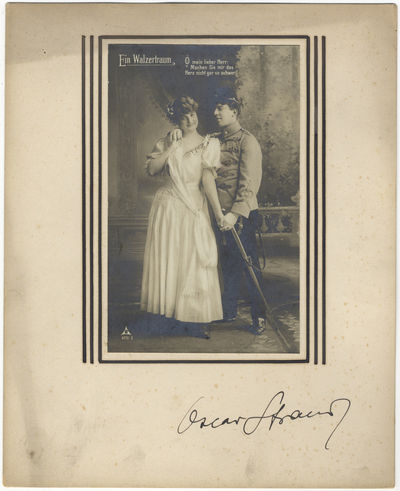 Autograph signature on mount below vintage postcard photograph of characters from the composer's operetta "Ein Walzertraum.