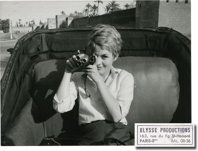 France: Ulysse Productions, 1964. Vintage borderless photograph of a playful Jean Seberg pointing he...