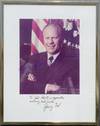 Gerald Ford Signs An Oversized Photograph