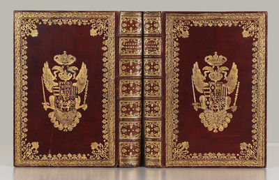 Deluxe manuscript fair copy on paper prepared for Emperor Francis I (title leaves on vellum) entitled “Catalogo Delle Produzioni Naturali che si conservano nella Galleria Imperiale di Firenze[.] Disteso nell’ Anno 1763. per Comando di Sua Maesta Cesarea partecipato da Sua Eccellenza il Sigr. Maresciallo Marchese Antoniotto Botta Adorno[.] Dall Dottr. Giovanni Targioni Tozzetti Decano del Collegio Medico di Firenze Professor Pubblico di Bottanica Prefetto della Bibliotreca Pub. Magliabechiana.” Written throughout, with the exception of the calligraphic titles, in one clear cursive hand in brown ink. Titles for each vol. written in black ink within elaborate calligraphic rococo framed border, elaborate imperial arms at top, one line of title in gold. 1 p.l. (title), 338 unnumbered leaves, 3 blank leaves; 1 p.l. (title), 123 unnumbered leaves, 3 blank leaves; 126 unnumbered leaves, one blank leaf. Three parts in two vols. Small folio (307 x 210 mm.), orig. red morocco, richly gilt, sides decorated with flo