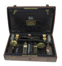 Fitted brown calf case for medecines, with 12 beakers (missing 4), scale, folding inner lid with clasps, with 2 outer clasps and carrying leather handle