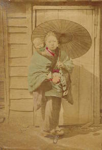 Japanese woman with child and umbrella, in front of wooden door.