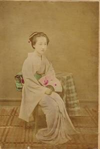 Japanese woman seated holding fan.