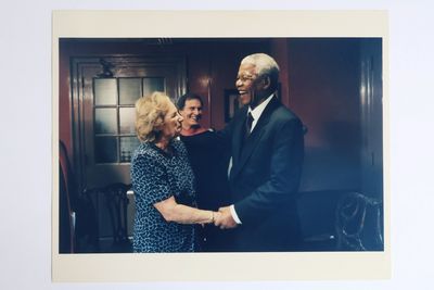 NELSON MANDELA SHAKING HANDS WITH A WOMAN PHOTOGRAPH [Signed by Mandela]