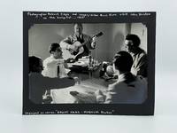 Photograph of Robert Capa and Burl Ives visiting John Huston in the hospital, 1953