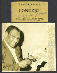 Robeson's signature clipped from a London concert program together with US Press Photograph of Robeson holding congratulatory telegrams