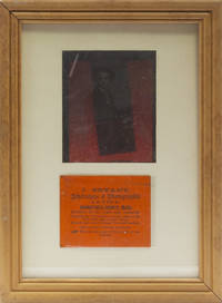 An ambrotype of a young man, seated with a lap robe at a table with a bottle of wine