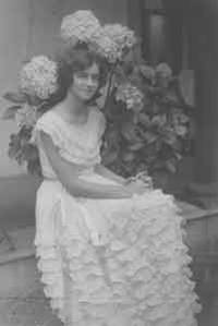 Portrait of unidentified young woman with hydrangeas.