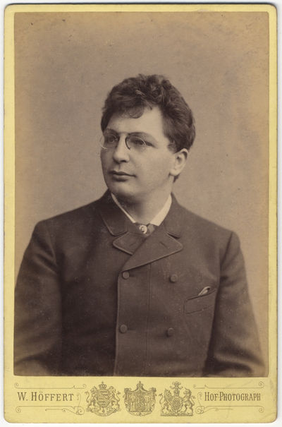 Bust-length cabinet card photograph in formal attire