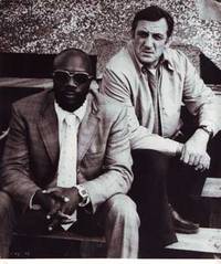 Publicity still of Issac Hayes and Lino Ventura in Tough Guys (1974) by Columbia Films S.A - from Alan Wofsy Fine Arts (SKU: 08-0036)