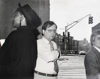 Man on corner looking at camera