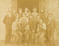 A vintage photograph of staff at Chateau Tanunda Winery in the Barossa Valley, South Australia; most of them are raising glasses of house wine, and those seated are on barrels by [Barossa Valley]