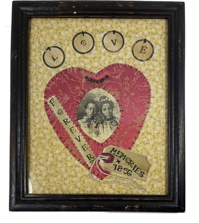 Framed Fabric Handwork with Image of Two Unidentified African American Women stitched in the center of a red fabric heart which is stitched in the center of other patterned material with appropriately placed words adding sentiment