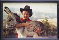 Photo of Cleveland Amory with Grand Canyon burro in his arms: Inscribed: "For Richard (Scaife) who helped so much to make the Grand Canyon rescue possible. Cleveland.